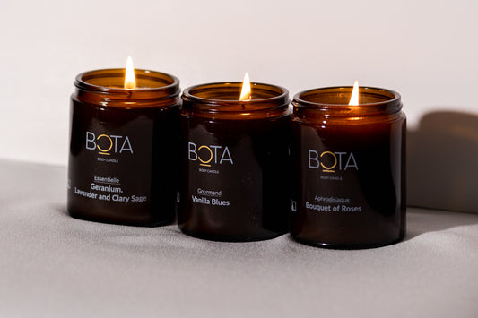 picture of bouquet of roses, Geranium, lavender and clary sage and vanilla blues body candle.  All candles are lit